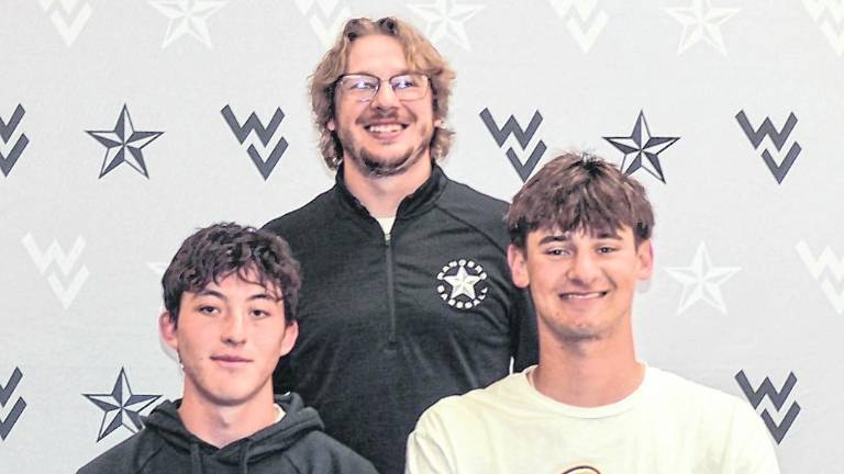 From left, Ryan Miller, Coach Connor Kopnik and Tyler Haberstroh pose for a photo.
