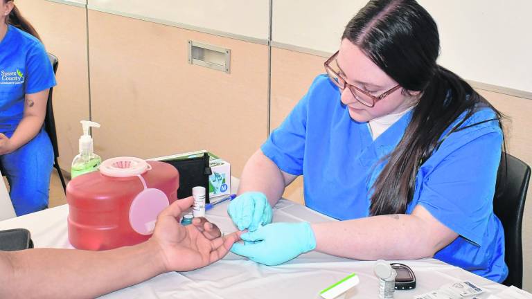 Emma Verniero of Newton checks blood for cholesterol.