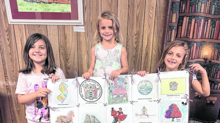 Girl Scouts from Troop 98765 in Ogdensburg pose with the quilt created by 7 different troops in the Wallkill Valley area.