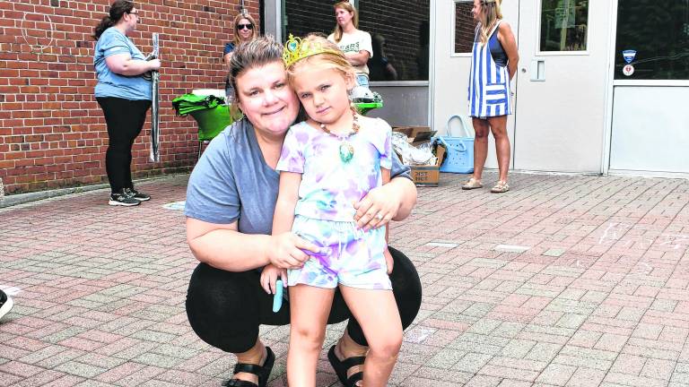 Megan and Abigail Guarducci of Ogdensburg pose next to a picture of a rainbow.