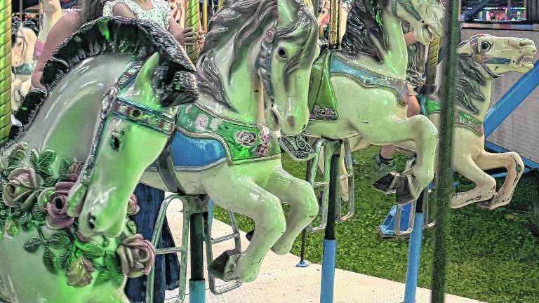 <b>Children ride the carousel.</b>