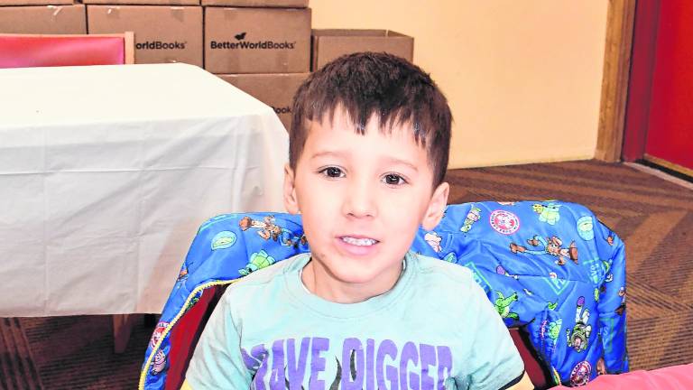 Domenic Card of Jefferson poses in front his art project.