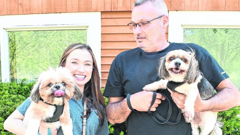 Kelsey and Gary Westerkamp are shown with two dogs.