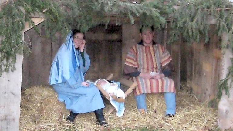 The Vitulli family — Chiara, James and baby James — portray the Holy Family of Mary, Joseph and baby Jesus (Photo by Janet Redyke)