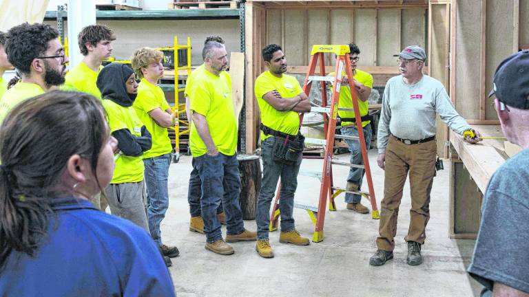 Stan Hankison instructs a plumbing class.